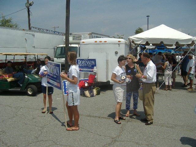 Democrat Congressional candidate Chris Robinson (far right, in white shirt and tie) talks with some of his small legion of helpers at the Tawes Crab and Clam Bake. Democrat Congressional candidate Chris Robinson (far right, in white shirt and tie) talks with some of his small legion of helpers at the Tawes Crab and Clam Bake.