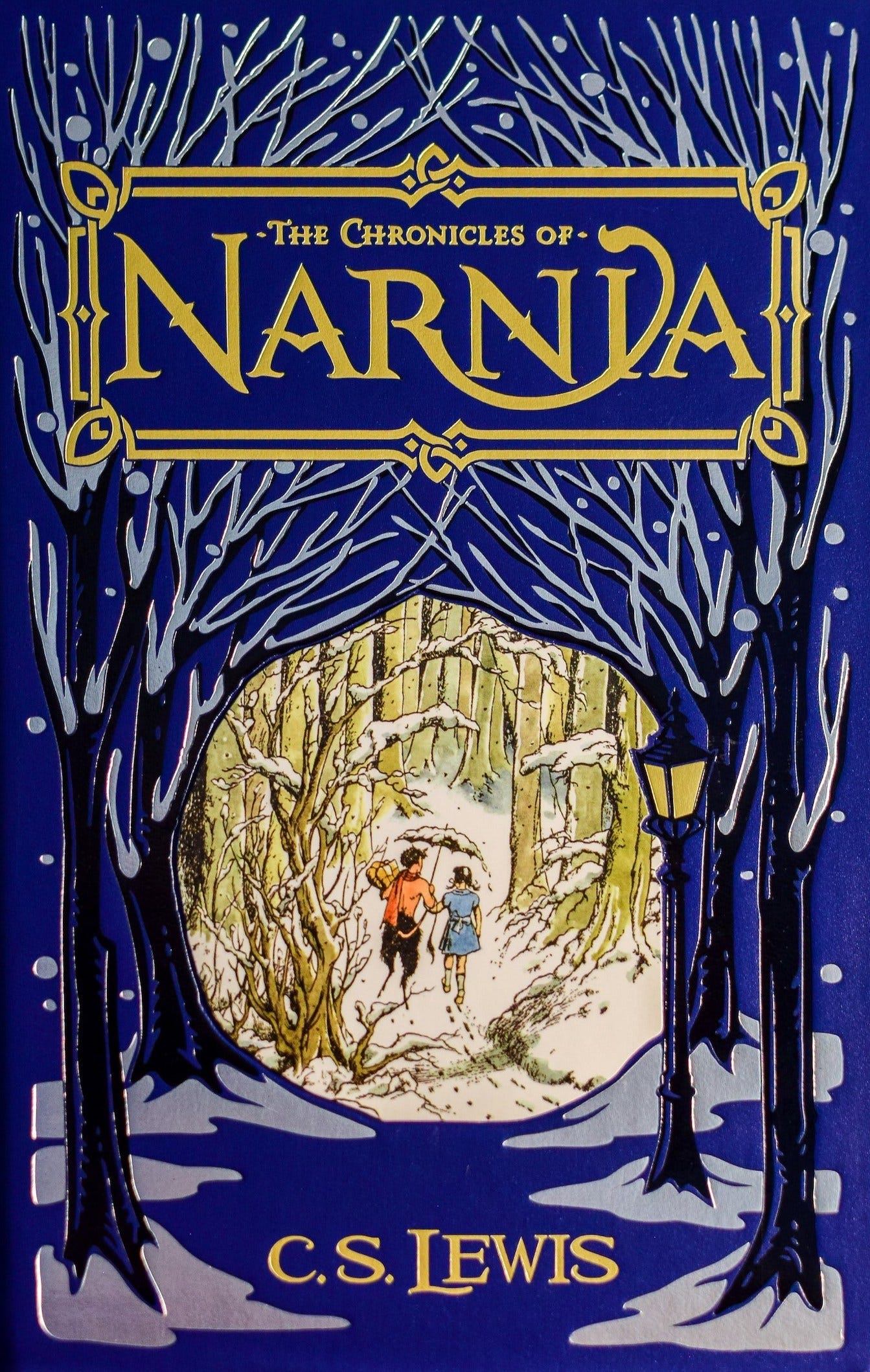 Cover of Chronicles of Narnia book showing Lucy and Mr. Tumnus