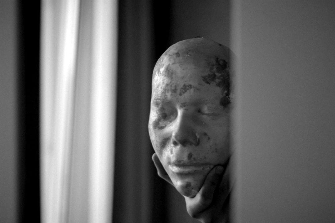 person holding white face mask person holding white face mask