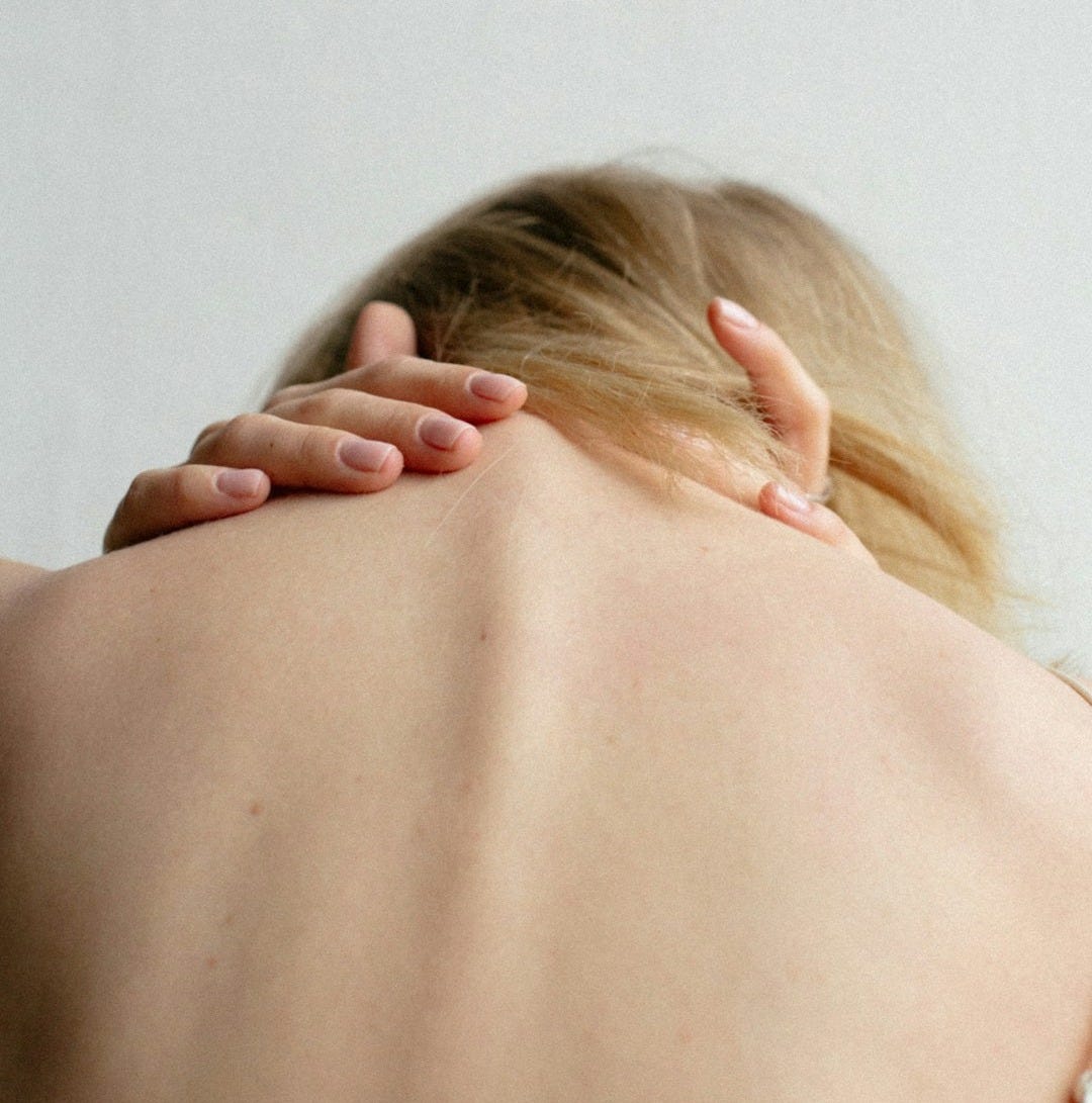 woman covering her breast with her hand woman covering her breast with her hand