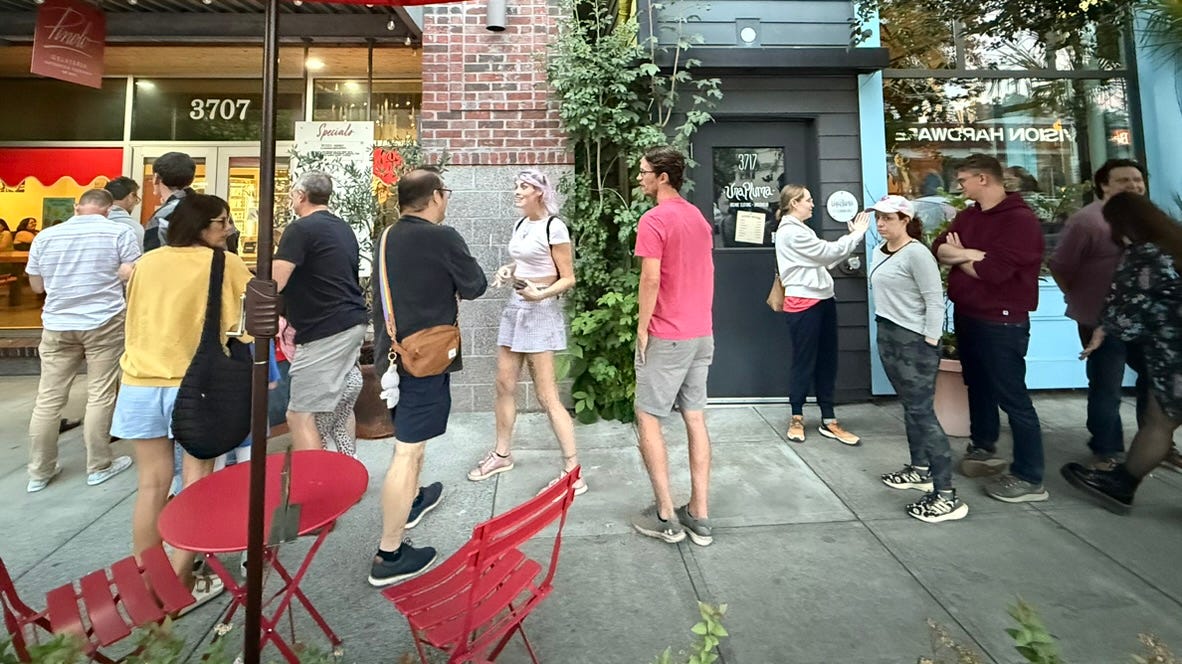 A dozen people wait in line outside a gelato shop in Portland, Oregon. 