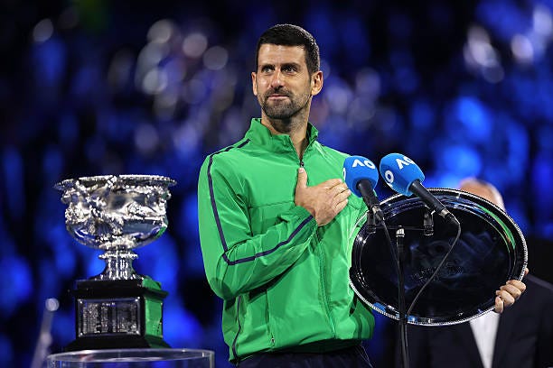 Runner-up Novak Djokovic of Serbia speaks with the finalist plaque at the presentation ceremony after the Men's Singles Final against Carlos Alcaraz... Runner-up Novak Djokovic of Serbia speaks with the finalist plaque at the presentation ceremony after the Men's Singles Final against Carlos Alcaraz...