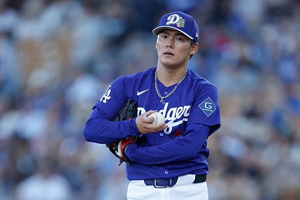 Yoshinobu Yamamoto of the Los Angeles Dodgers stands on the pitcher's mound during a Spring Training game against the San Diego Padres at Camelback... Yoshinobu Yamamoto of the Los Angeles Dodgers stands on the pitcher's mound during a Spring Training game against the San Diego Padres at Camelback...