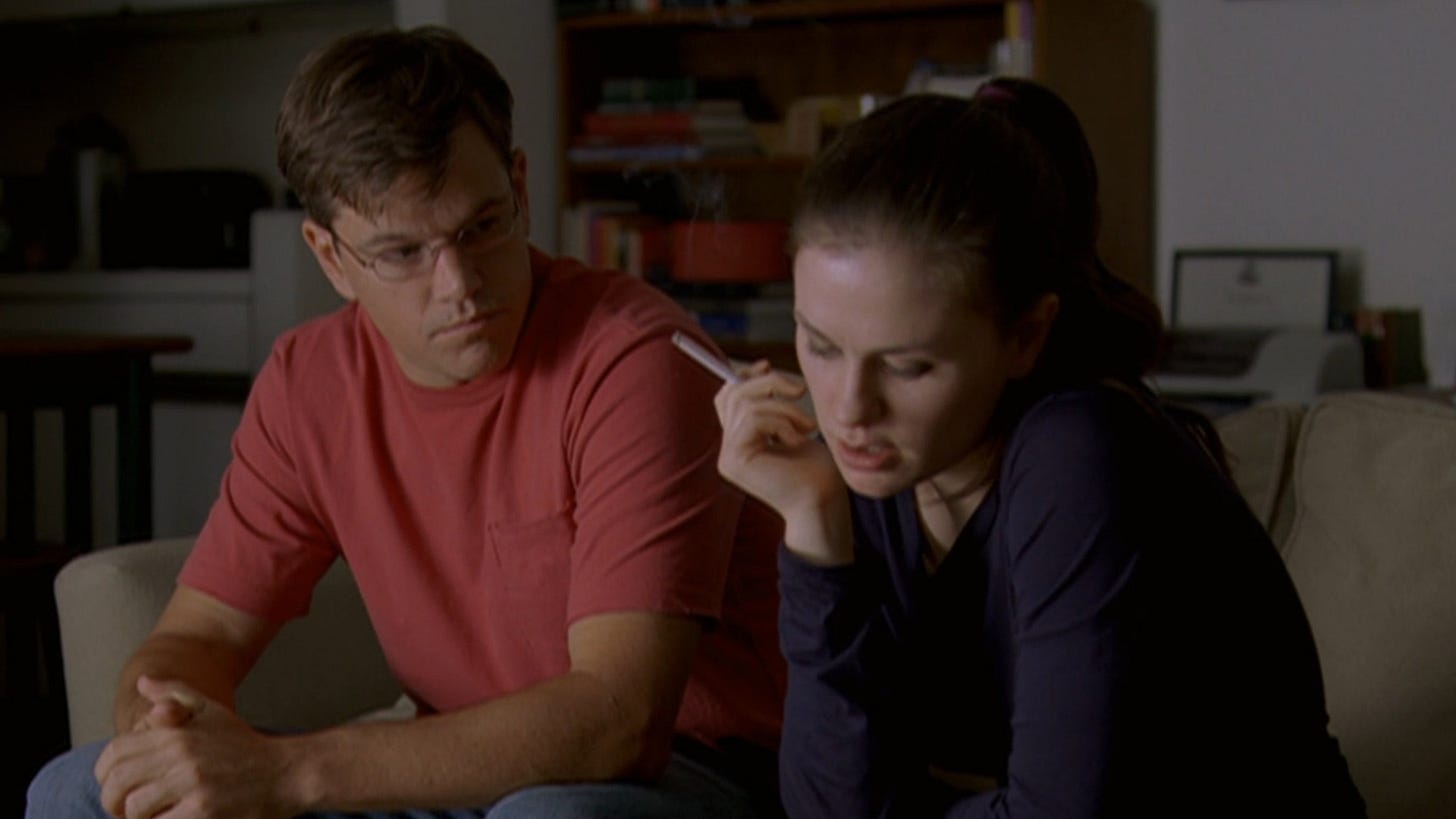 Margaret | Still features Anna Paquin smoking a cigarette next to Matt Damon.