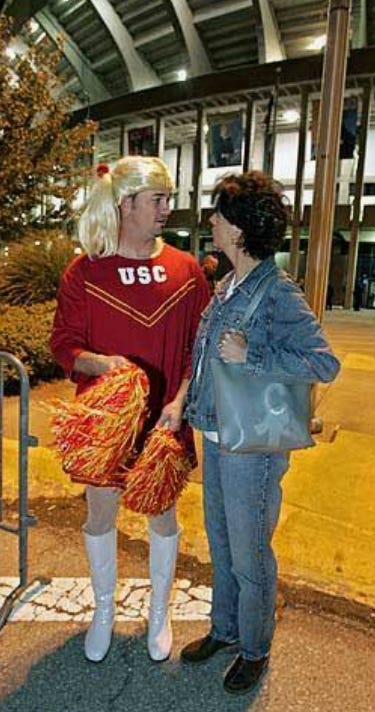 Kyle Denney talks to his mother while wearing a cheerleader costume outside Kauffman Stadium. Kyle Denney talks to his mother while wearing a cheerleader costume outside Kauffman Stadium.