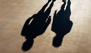 Two human shadows, one taller than the other.