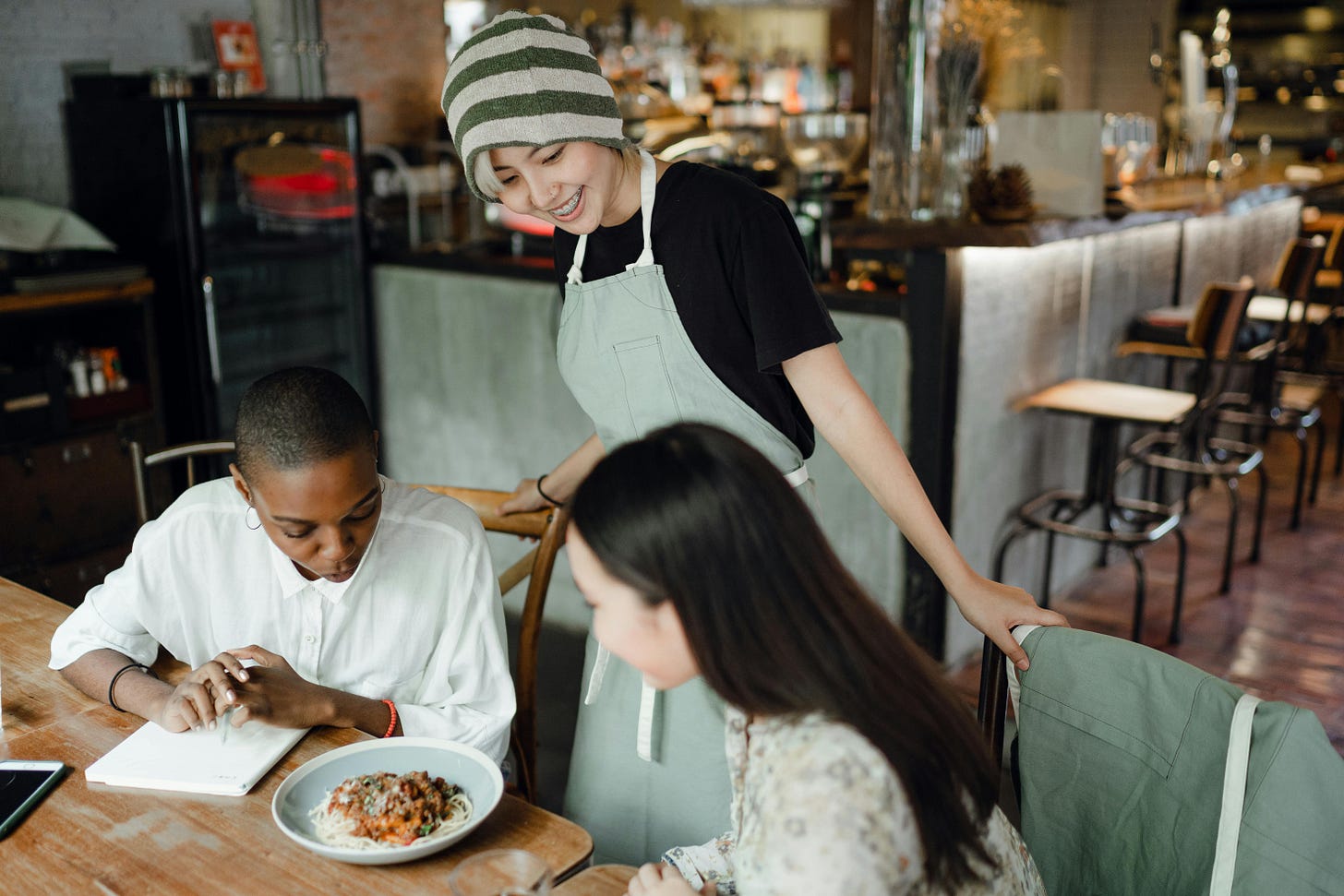 Employee interacting with customer at a restaurant.