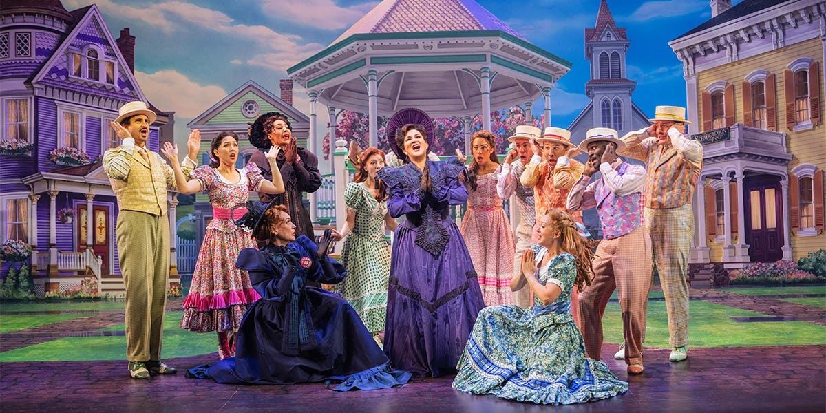 Ana Gasteyer stands center singing, and the ensemble surrounds her in shock Ana Gasteyer stands center singing, and the ensemble surrounds her in shock