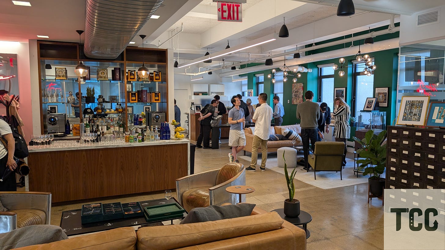 A bar in the background and a couch and lounge chairs in the foreground.