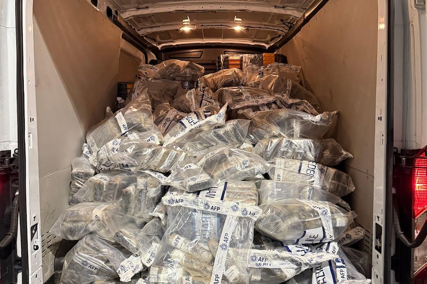 A large amount of packaged drugs inside the boot of a van, up to the vehicle's ceiling. A large amount of packaged drugs inside the boot of a van, up to the vehicle's ceiling.