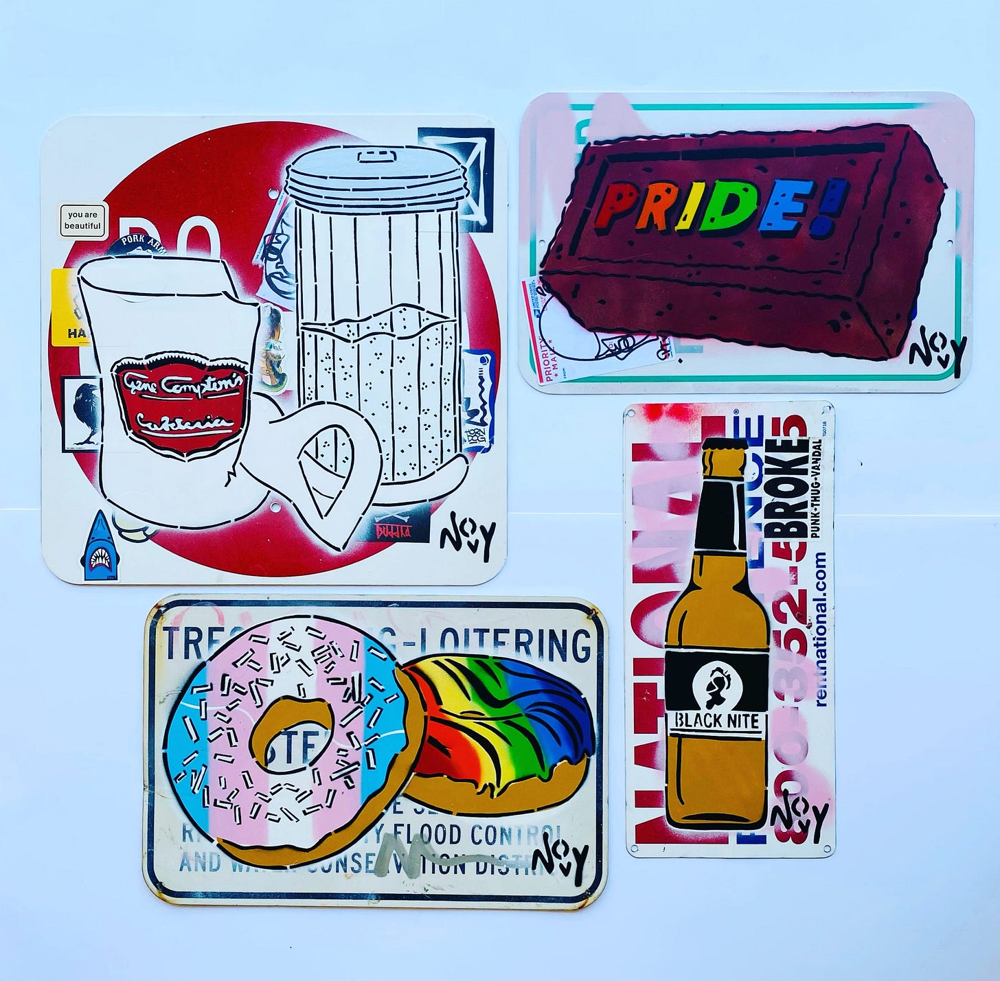 A collage of colorful works featuring diverse themes: a brown "Pride!" brick, donuts in trans and rainbow colors, a sugar and broken mug sketch, and a beer bottle. Each has vibrant, playful designs with a sense of humor and diversity. Each one is on an existing street sign, and has additional graffiti behind them. Each one represents a different queer theme or symbology, like Stonewall, or the Black Nite brawl, or Compton Cafeteria riot. Jeremy's signature, Novy, in is black in the bottom right corner of each work. A collage of colorful works featuring diverse themes: a brown "Pride!" brick, donuts in trans and rainbow colors, a sugar and broken mug sketch, and a beer bottle. Each has vibrant, playful designs with a sense of humor and diversity. Each one is on an existing street sign, and has additional graffiti behind them. Each one represents a different queer theme or symbology, like Stonewall, or the Black Nite brawl, or Compton Cafeteria riot. Jeremy's signature, Novy, in is black in the bottom right corner of each work.