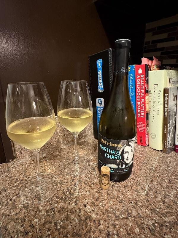 A bottle of wine next to two glasses of wine

Description automatically generated