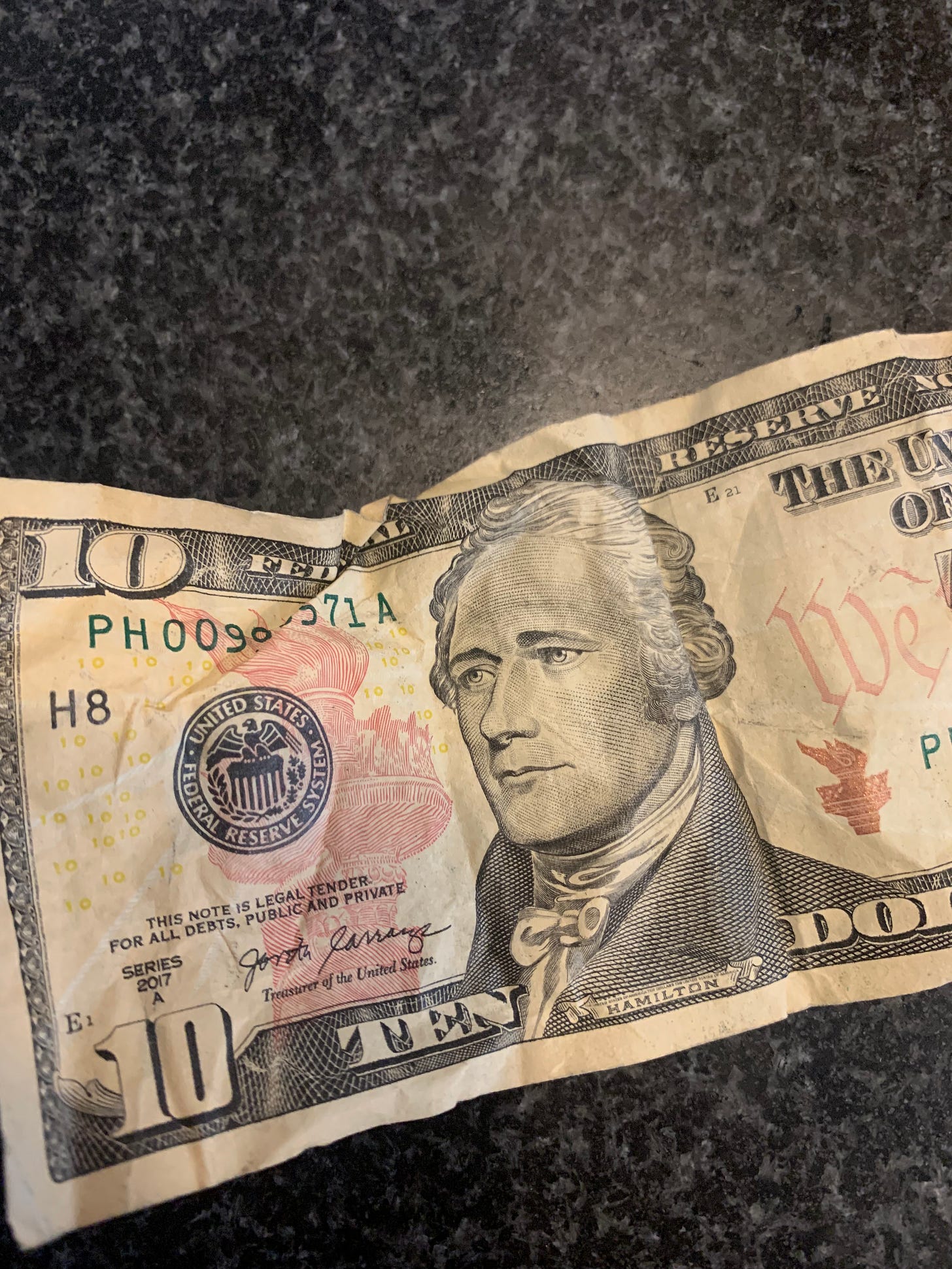 a photo of a crumpled ten dollar bill