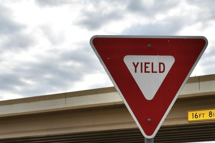a yield sign on the side of the road a yield sign on the side of the road