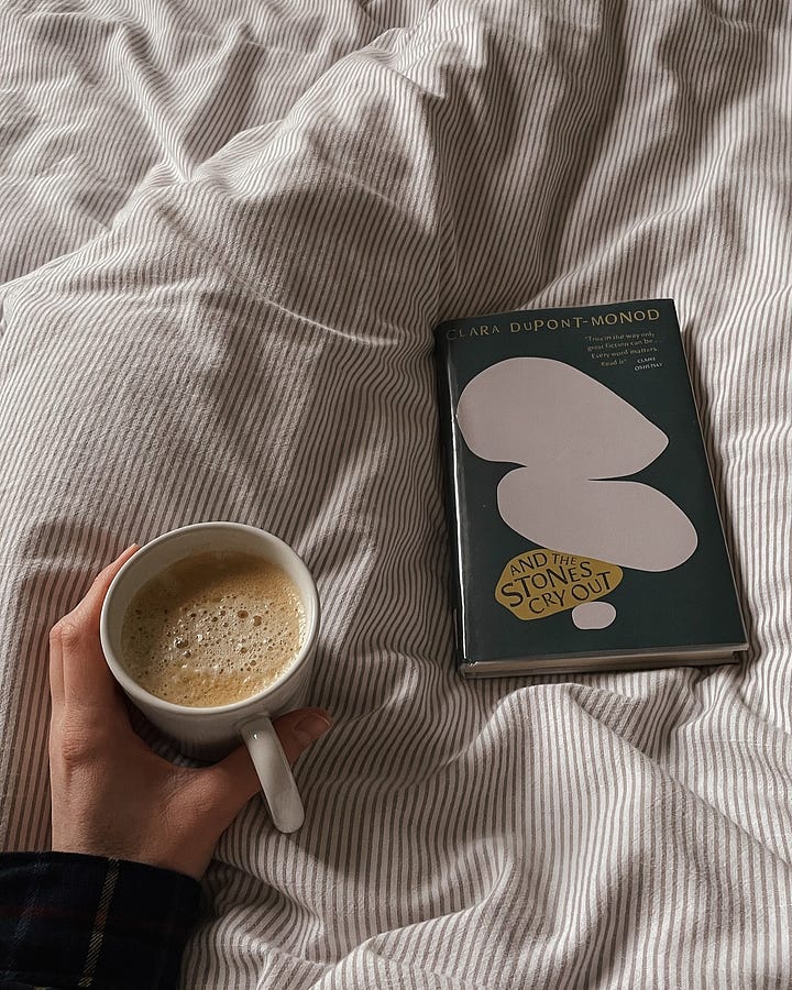 Image 1: A cosy moment in bed—coffee in hand, book resting nearby (And the Stones Cry Out by Clara Dupont-Monod), waiting to be opened. / Image 2: The book is now open, coffee still in hand—ready to dive in.