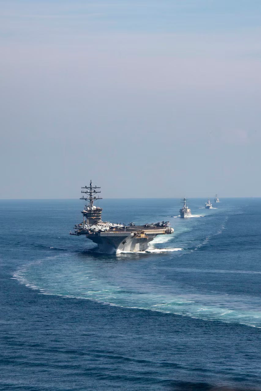 (Nov. 26, 2023) The Dwight D. Eisenhower Carrier Strike Group (IKECSG) transits the Strait of Hormuz, Nov. 26. The IKECSG is deployed to the U.S. 5th Fleet area of operations to support maritime stability and security in the Middle East region. - Photo By: Mass Communication Specialist 2nd Class Merissa Daley