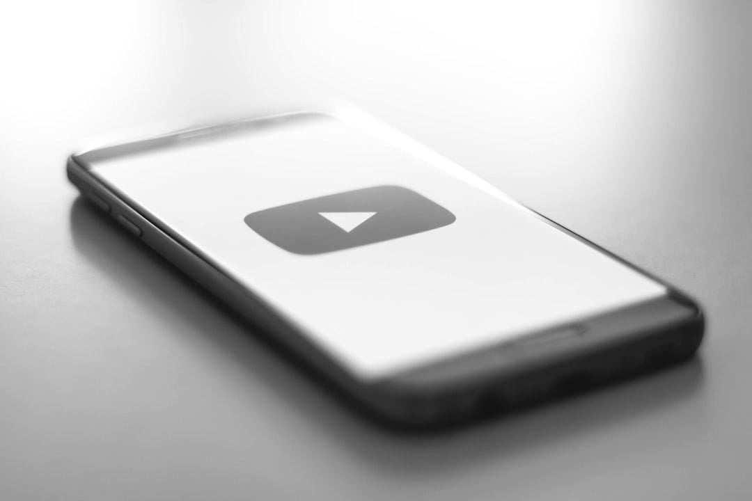 a close up of a cell phone with a youtube logo on it a close up of a cell phone with a youtube logo on it