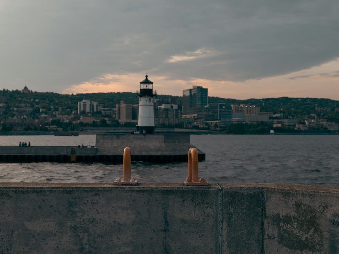 a light house sitting on top of a cement wall