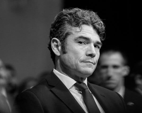 Joe Kent, wearing a suit, looks to the side.