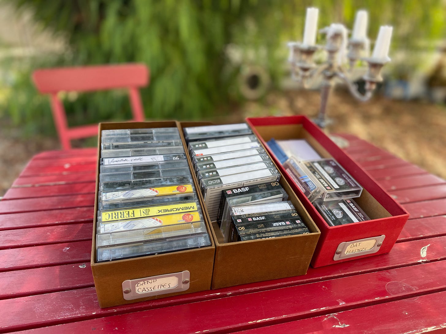 Picture of three boxes of audio and DAT cassette tapes on a table outside our home.