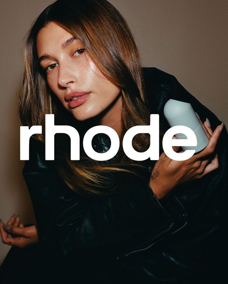 This may contain: a woman holding a hair dryer in her right hand and the words rhode on it