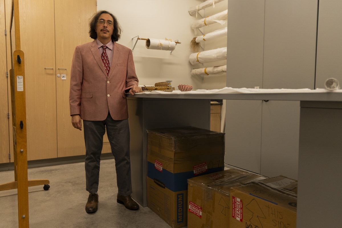 El Camino College anthropology professor Lawrence Ramirez stands in the backroom of the ECC anthropology museum near the box that stores a mummified skull Tuesday, Oct. 28. The skull was donated to the museum's former museum director Walt Foster in the late 1960s after being smuggled from Egypt, according to The Union's archives. (Oriana de Quay | The Union)