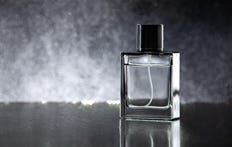 A perfume bottle against a dark background.