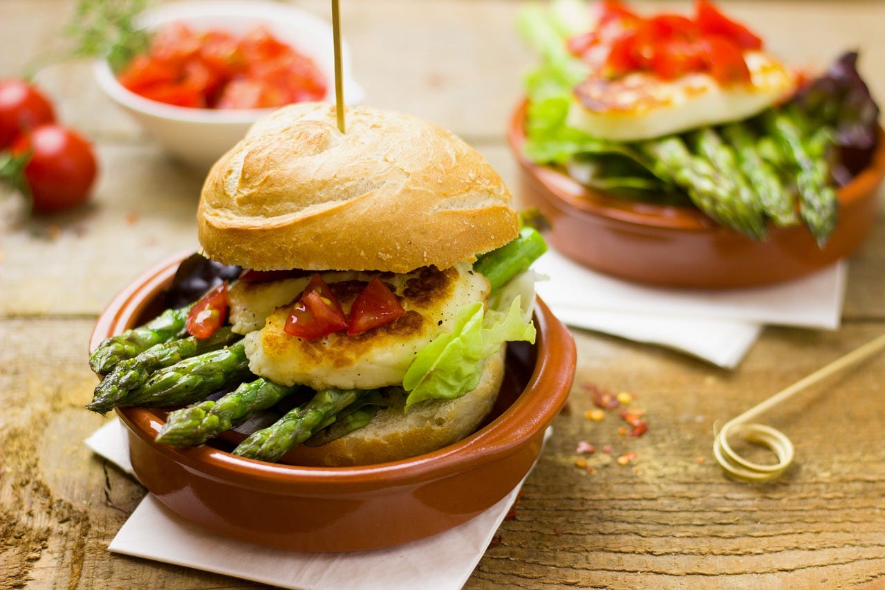 A bun containing asparagus pretending to be a veggie burger.