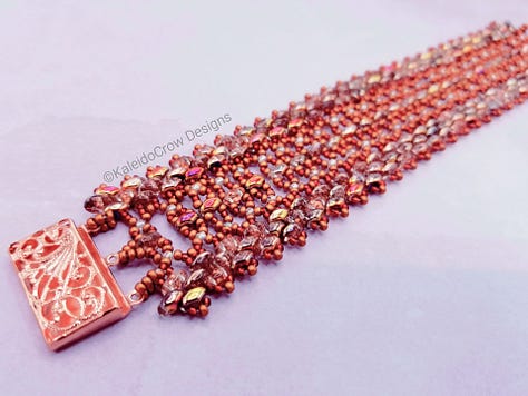 Photos of a beaded cuff bracelet in tones of copper and red with a bright copper box clasp