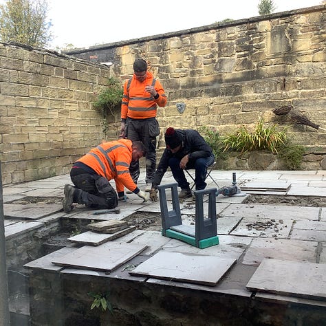 Five pictures of the patio in various stages of repair. First being pressure washed, second, three men is hi-vis clothing are gathered round one flag ‘discussing’ the work needed, third is a pic of lots of lifted flags and a lot of mess, fourth is he revealed steps of York stone and the relaid and regrouted old flags of many colours, the first is a picture of fags that have been regrouted, the grout is ina contrasting colour. 