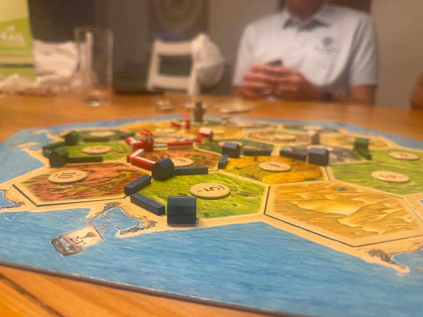 Catan board game showing the start with a few pieces on the board Catan board game showing the start with a few pieces on the board