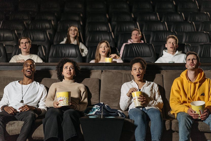 Image of people in a cinema with joy on their faces Image of people in a cinema with joy on their faces