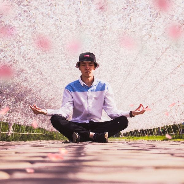man meditating under pink canopy