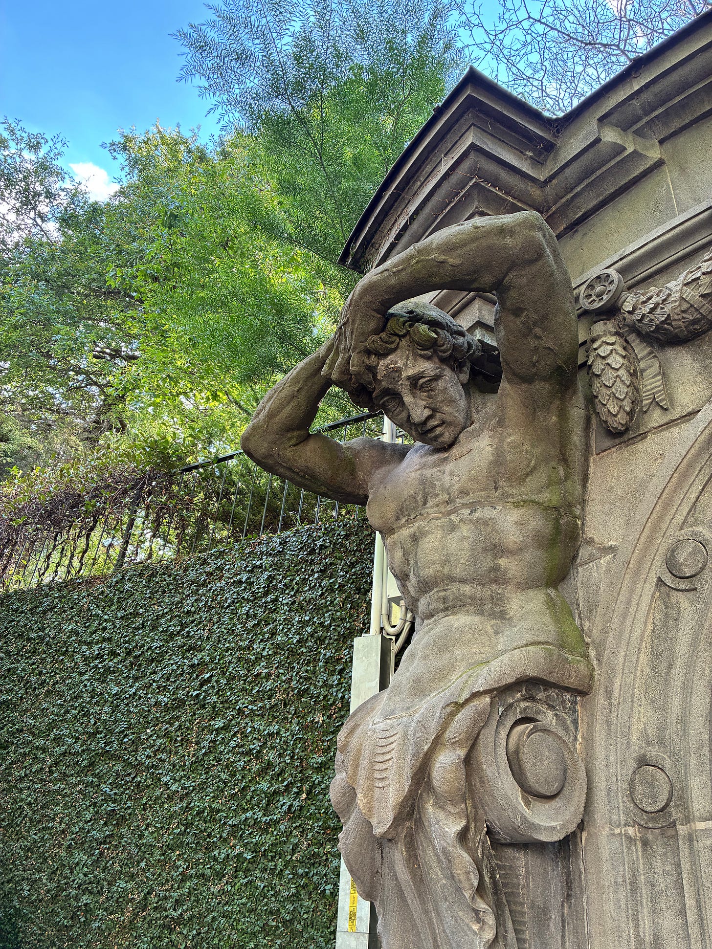 Piece of stuatuary outside the Univ of Melbourne carpark. The figure's hand are on his head, possibly pulling his hair out. Maybe, having gotten lost, perhaps he was turned to stone by the witch of Labyrinth