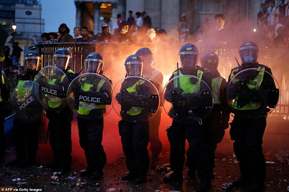 Lines of riot police guard Trafalgar Square as England fans take to the ...