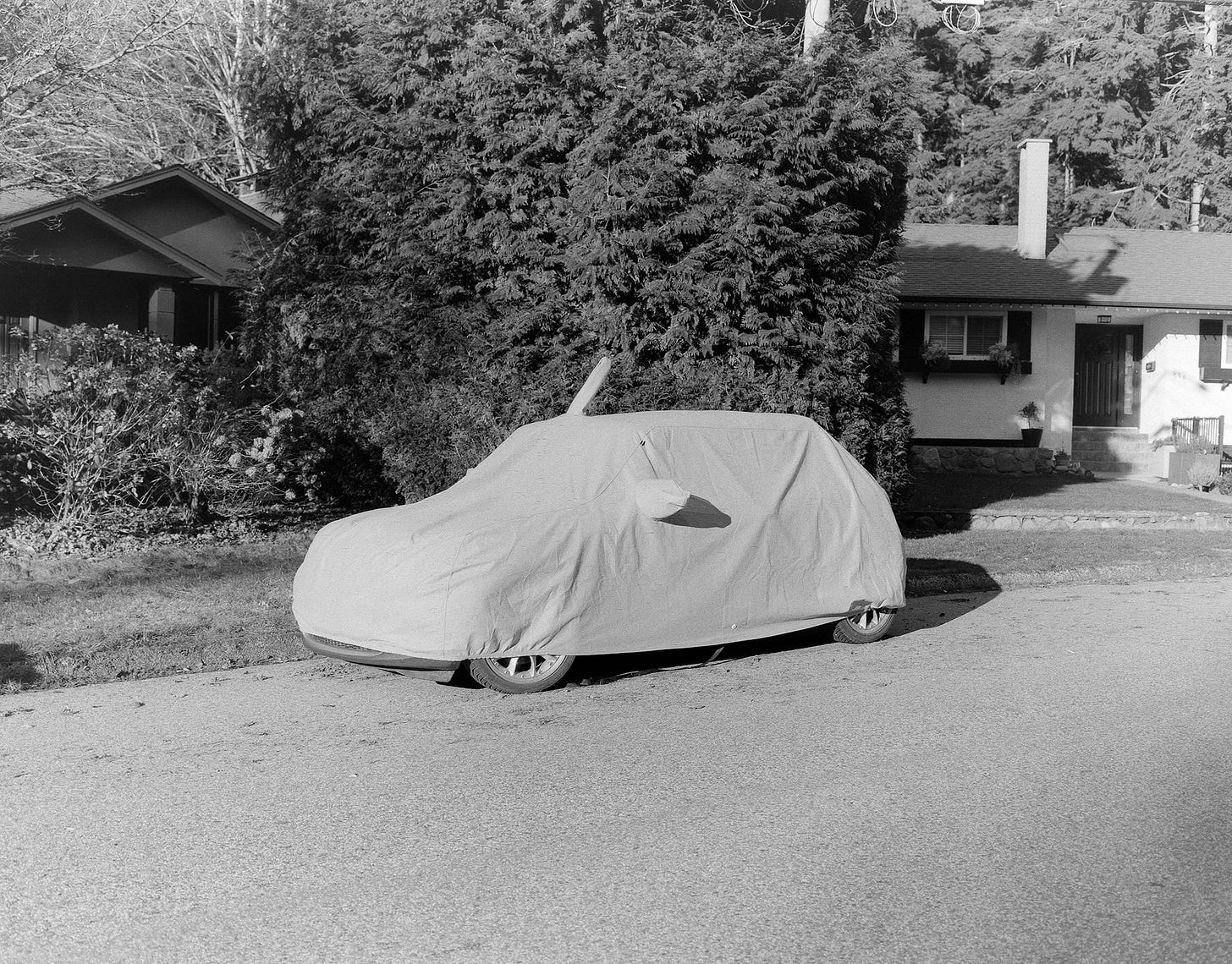 A parked car hidden under a protective cover