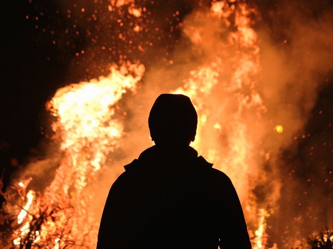person standing in front of fire