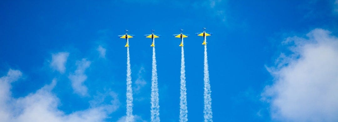 four stunt planes during daytime