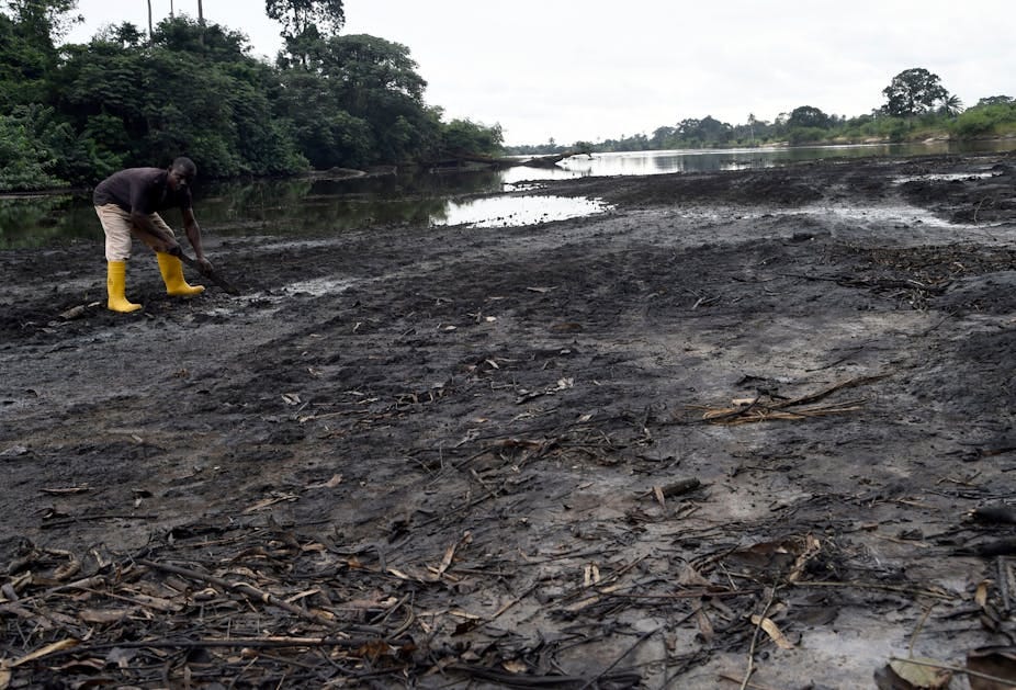 A man digging on a river shore A man digging on a river shore