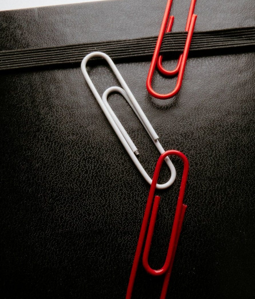 blue paper clip on black textile