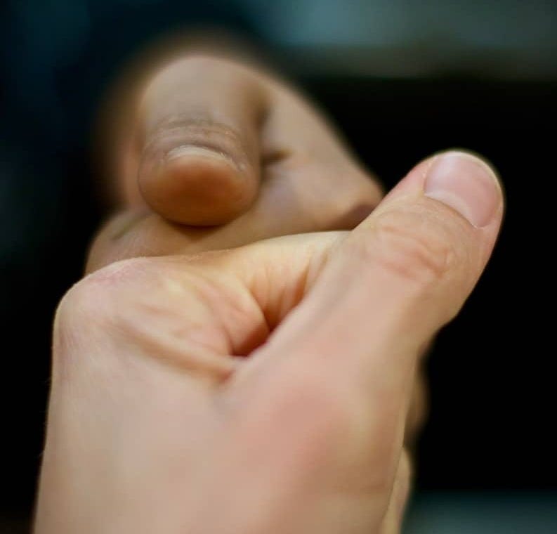 A close up of a person holding something in their hand