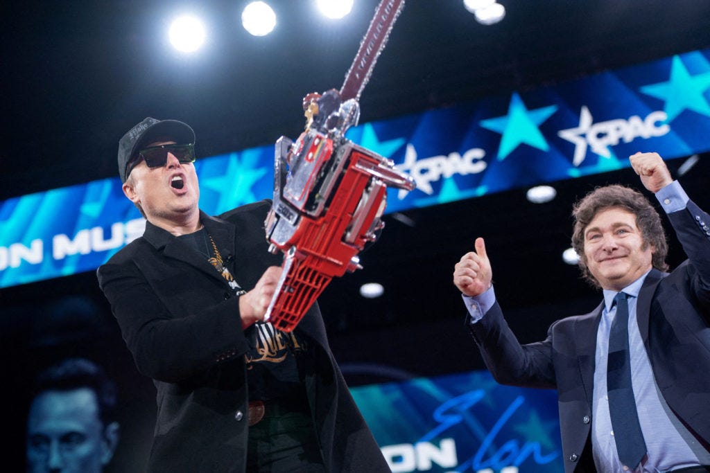 WATCH: Elon Musk wields 'chainsaw for bureaucracy' on stage before speaking  at CPAC | PBS News