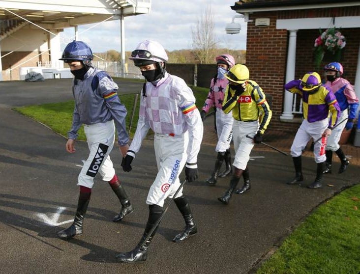 Photo of jockeys wearing rainbow armbands