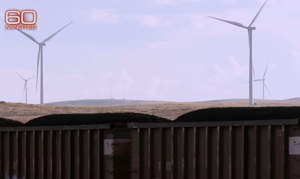 CBS '60 Minutes' video screenshot showing a coal train in the foreground and a wind farm in the background CBS '60 Minutes' video screenshot showing a coal train in the foreground and a wind farm in the background