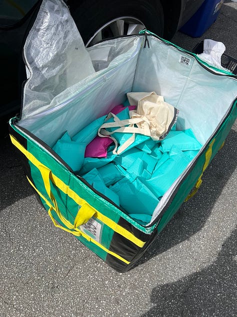 IMAGE 1: A white table with gray plastic bags full of dinner plates and safe sex kits. IMAGE 2: Stacks of black dinner plates and plastic bags on a wooden table. IMAGE 3: A green and yellow travel container full of safe sex kits. 