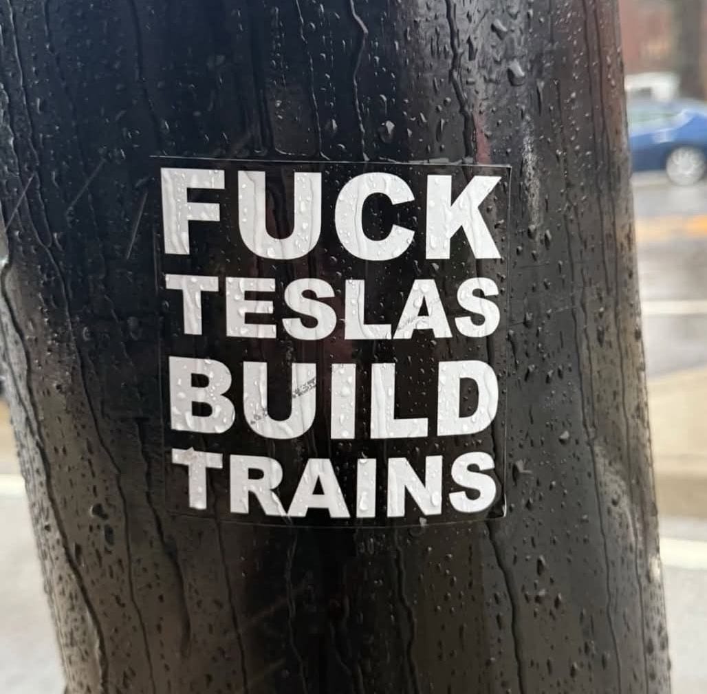 May be an image of text that says 'TATTOE FUCK TESLAS BUILD TRAINS'