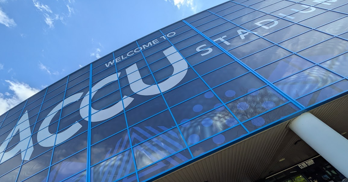 A photograph of the glass facade above the entrance to the Accu Stadium. A photograph of the glass facade above the entrance to the Accu Stadium.