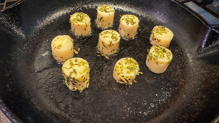 Side by side photos of the mushrooms (left) and the hearts of palm (right) which are covered in aonori flakes, searing in a cast iron skillet.