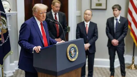 Getty Images Donald Trump stands at a lectern in the White House, flanked by Larry Ellison, Masayoshi Son and Sam Altman. Getty Images Donald Trump stands at a lectern in the White House, flanked by Larry Ellison, Masayoshi Son and Sam Altman.