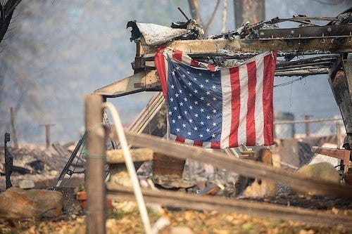Photo of a U.S. flag and debris after fire in Paradise, Calif. Photo of a U.S. flag and debris after fire in Paradise, Calif.